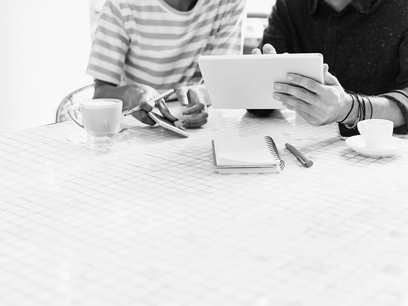 Colleagues discussing work on a table with design space